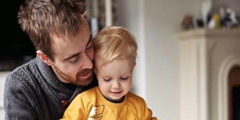 a father reading a book with his child
